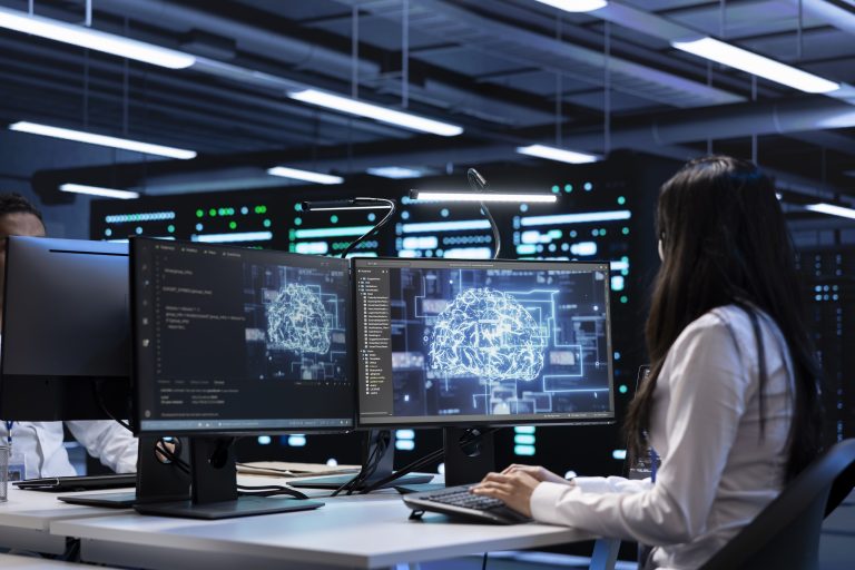 Technician using computer to do checkup in AI server room